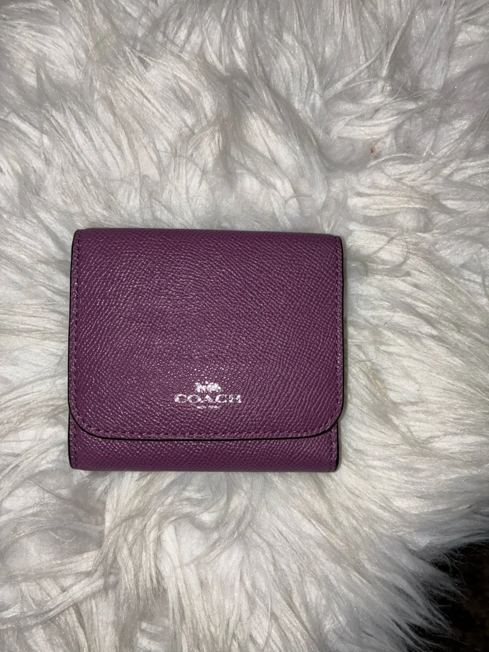 Coach Compact Trifold Pebbled Leather Wallet button closure in Plum/Purple.